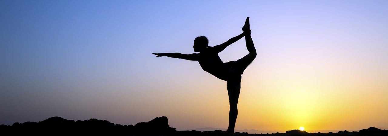 Female doing Yoga at Sunrise