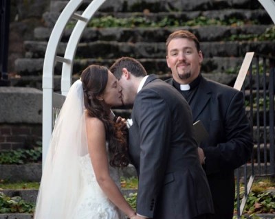 wedding kiss under an arch in the Camden Amphitheatre
