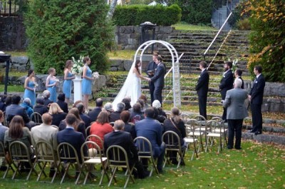 bride and groom under arch in Camden Amphitheatre wedding