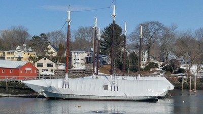 Schooner in shrink wrap in the harbor.